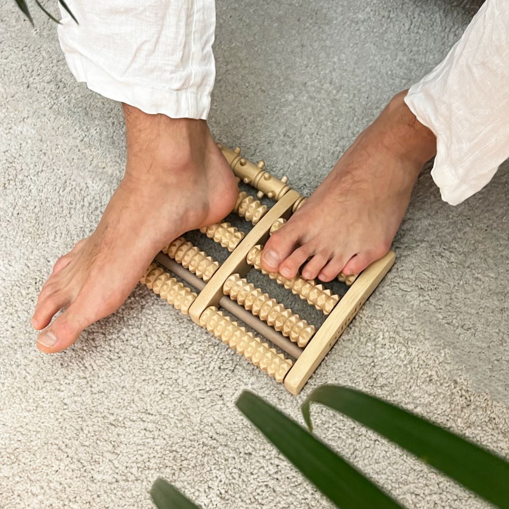 Sustainable wood foot therapy tool with ridged massage rollers