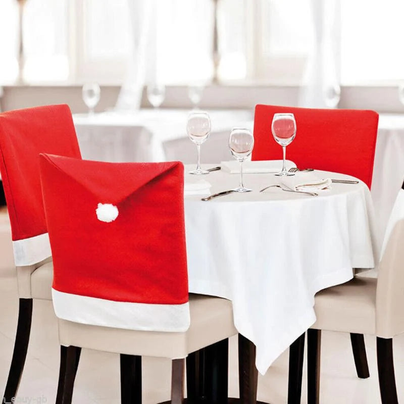 Christmas chair covers on dining chairs around a white tablecloth table