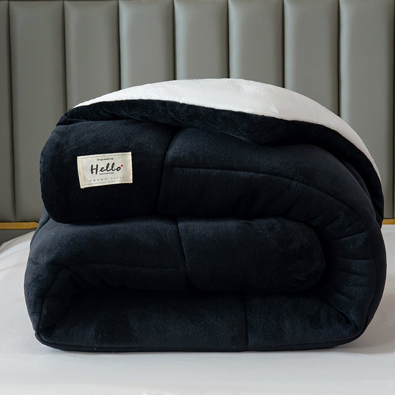 Black and white blanket with a 'Hello' label on a bed