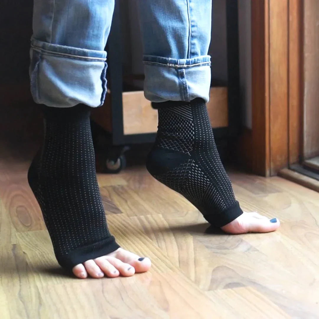 Close-up of plantar fasciitis compression socks on feet

