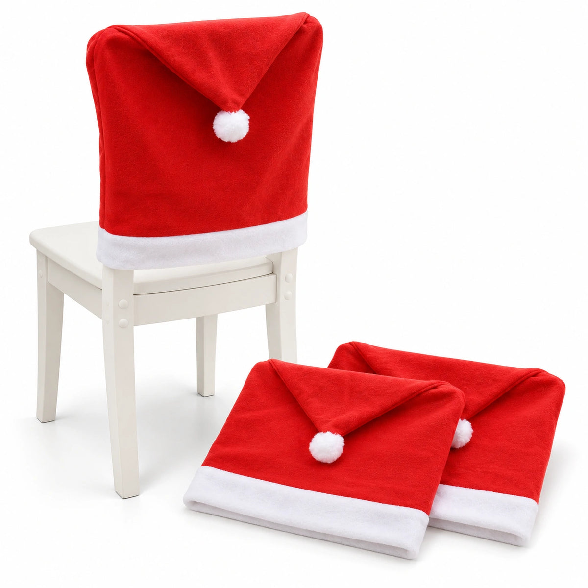 SantaSeat Christmas chair cover on a white dining chair with two folded Santa hat covers